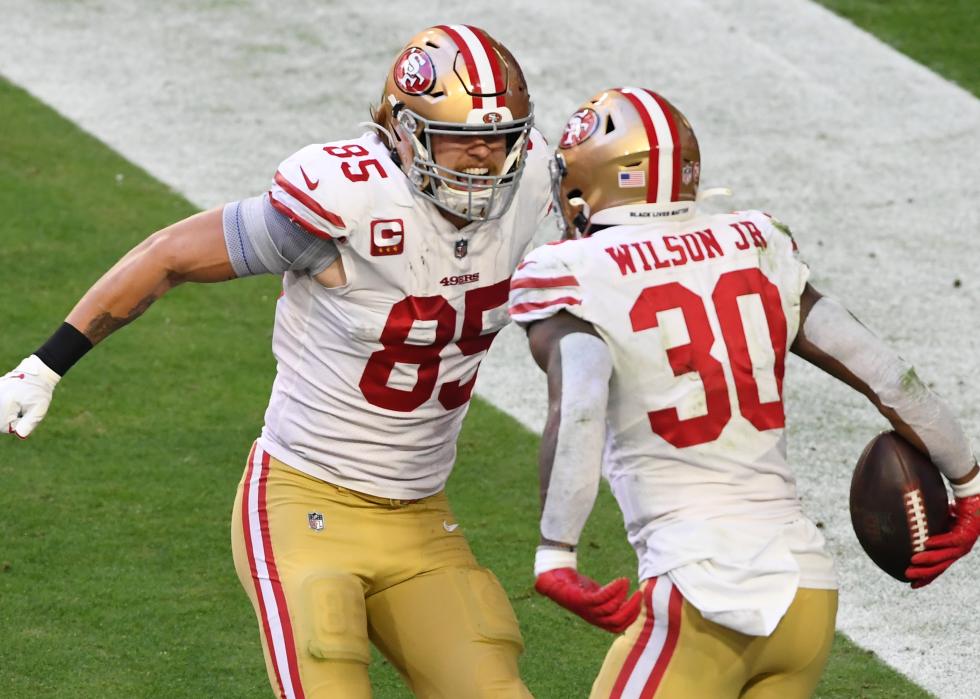 Jeff Wilson Jr. celebrates with tight end George Kittle of the San Francisco 49ers after a touchdown.