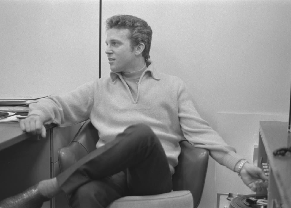 Bobby Vinton sitting and adjusting stereo equipment