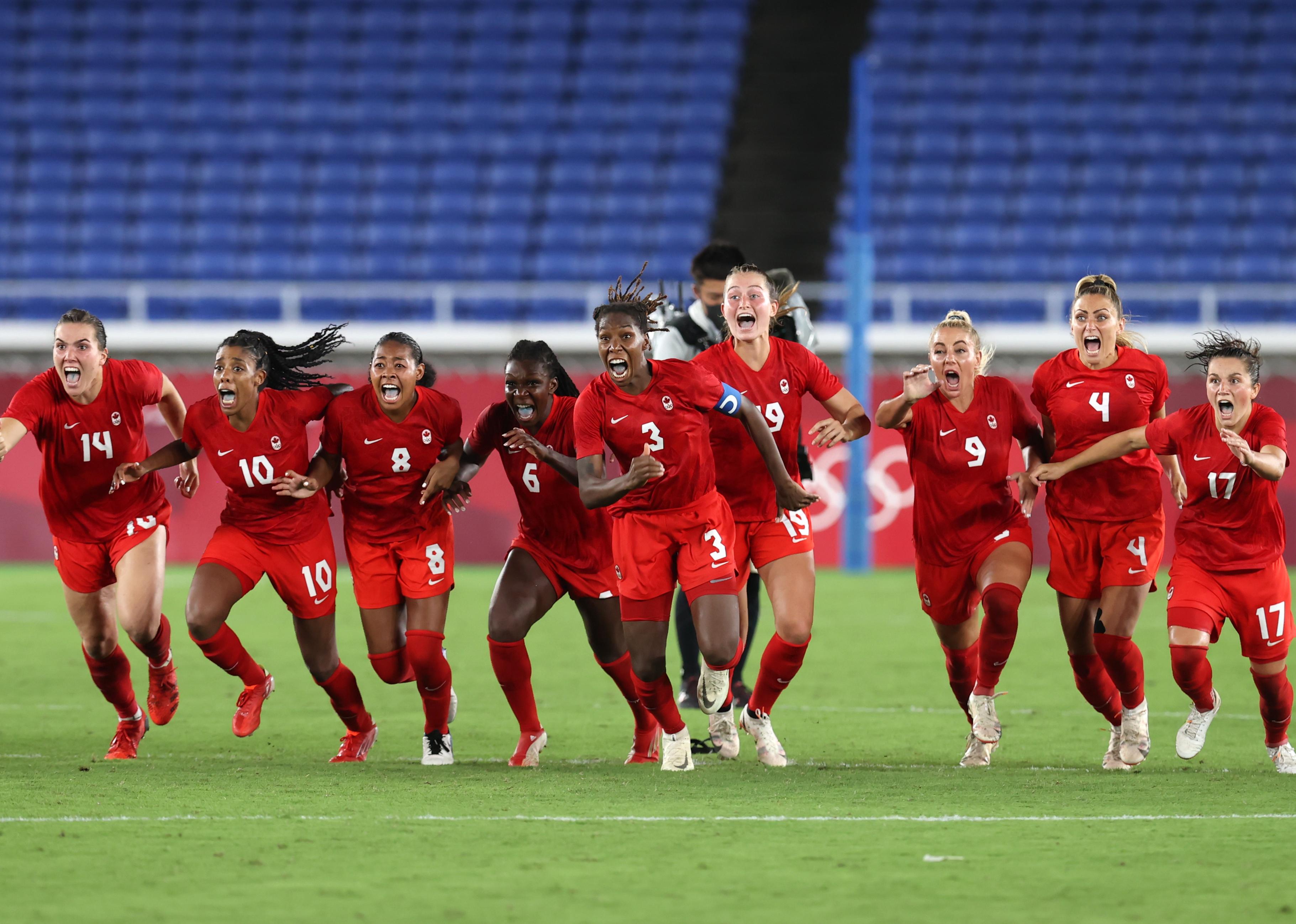 Kadeisha Buchanan of Team Canada and teammates run to celebrate the winning penalty in the shootout during the Women's Gold Medal Match.