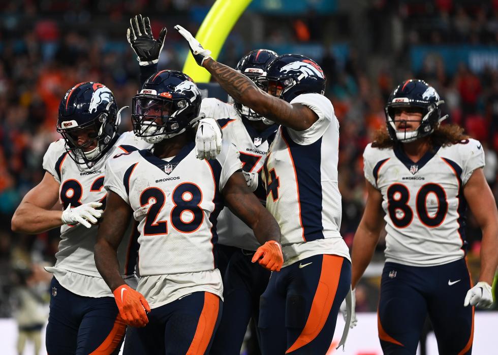 Latavius Murray #28 of the Denver Broncos celebrates with teammates after scoring a touchdown.