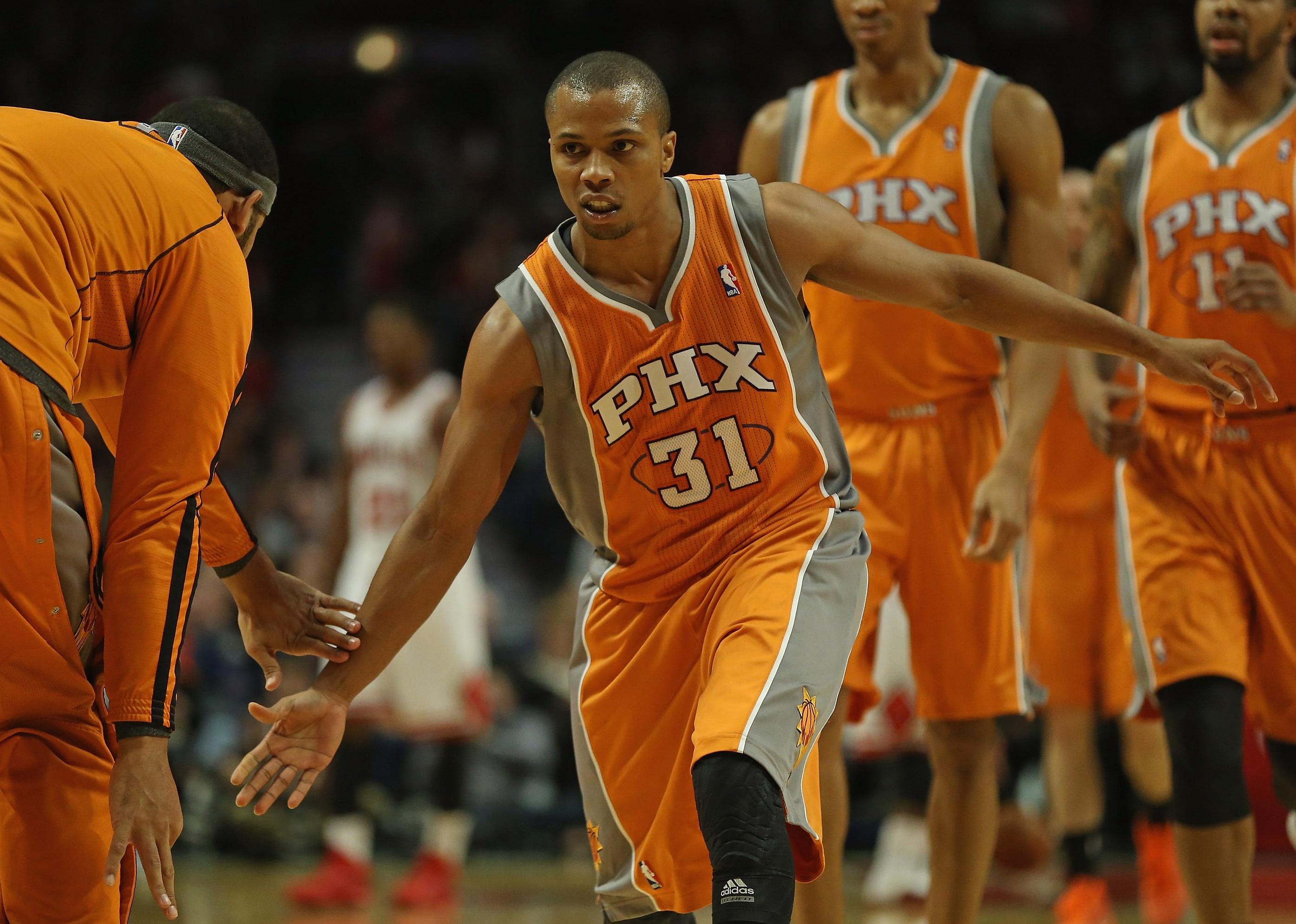  Sebastian Telfair of the Phoenix Suns is congratulated by teammates as he leaves the floor.