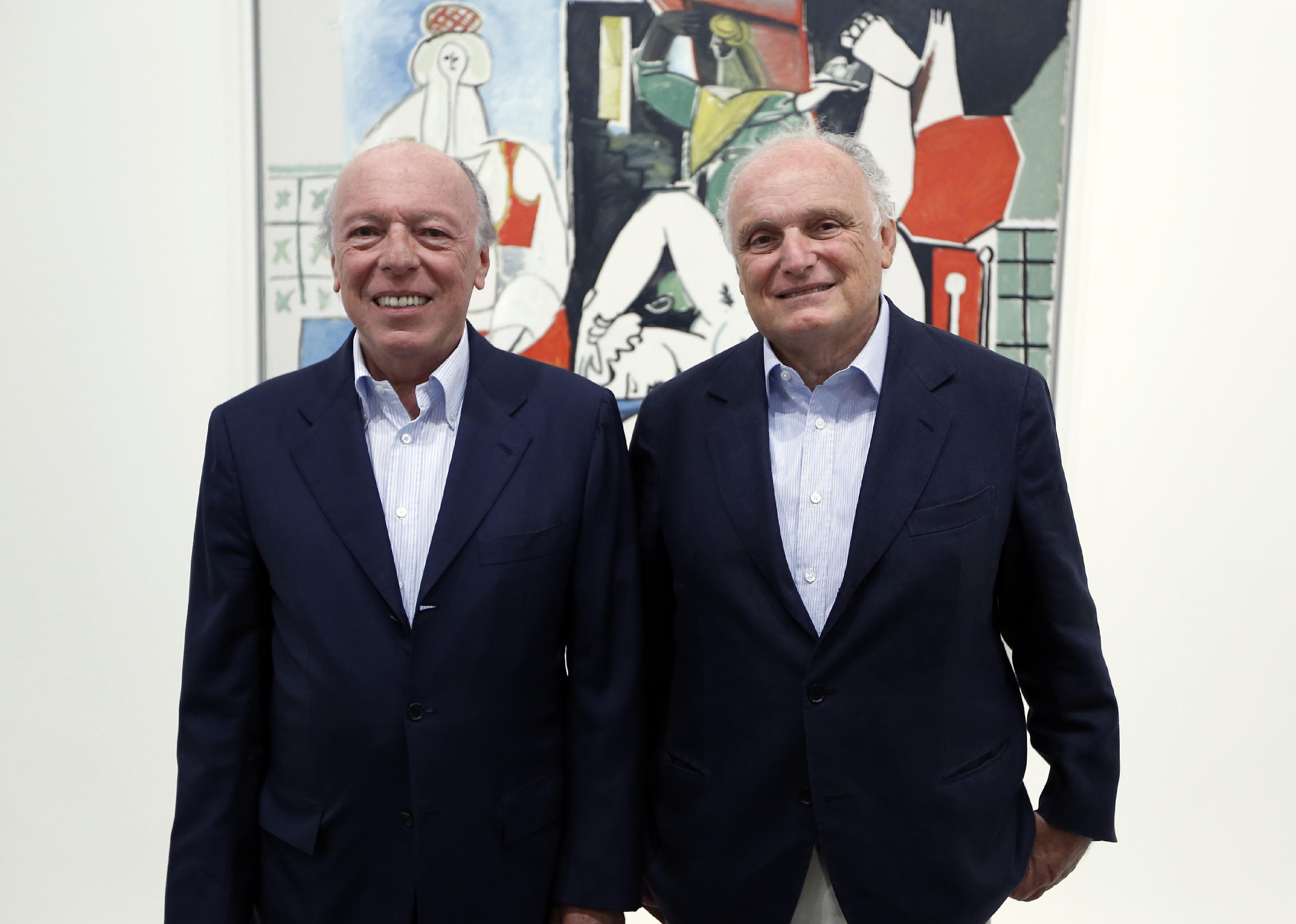 David Nahmad and Ezra Nahmad pose in a room of an exhibition dedicated to Pablo Picasso.