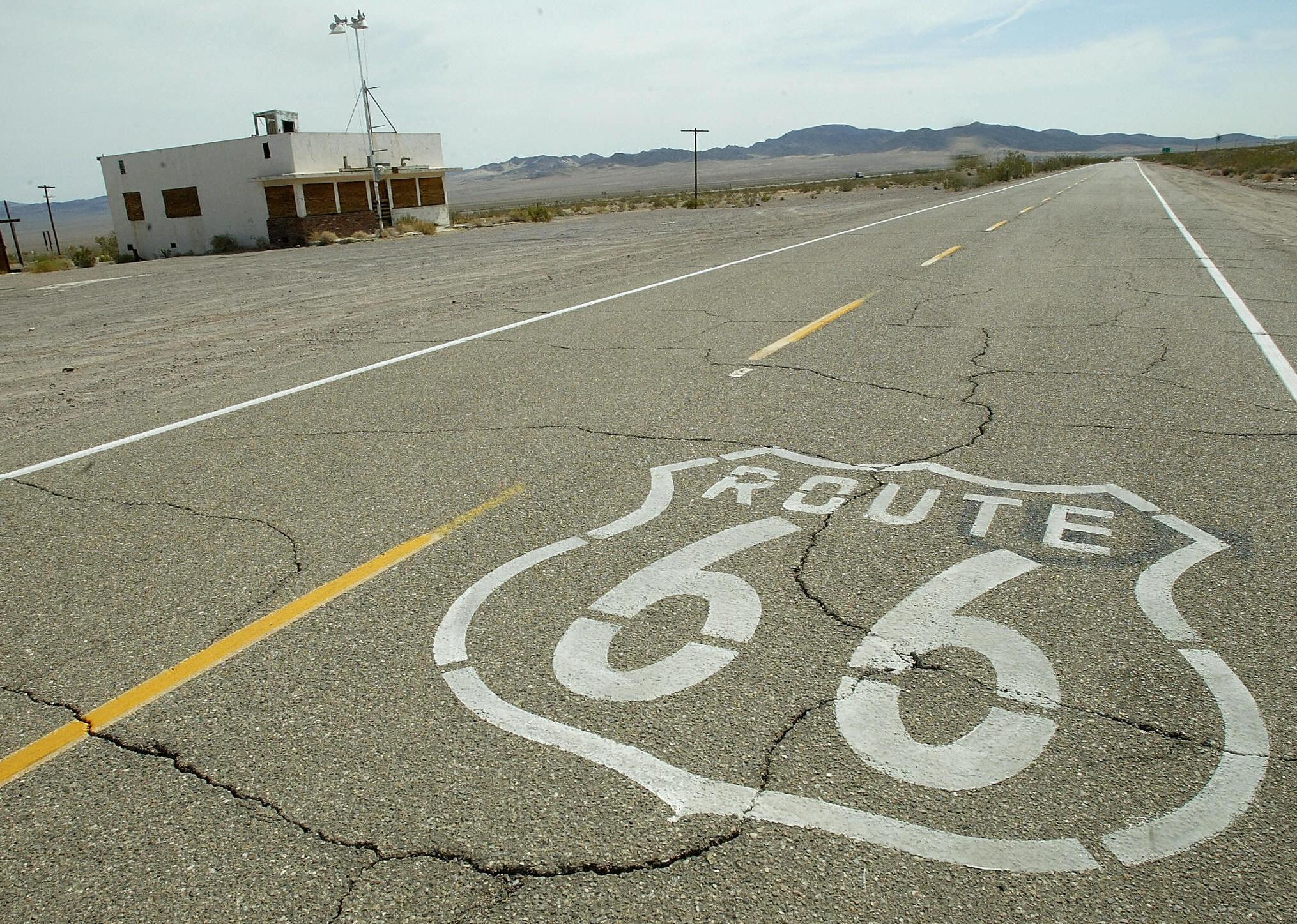 Route 66 painted on the old road through an abandoned town in California's Mojave desert.