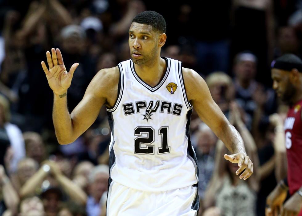 Tim Duncan with a hand up looking to the side during a game