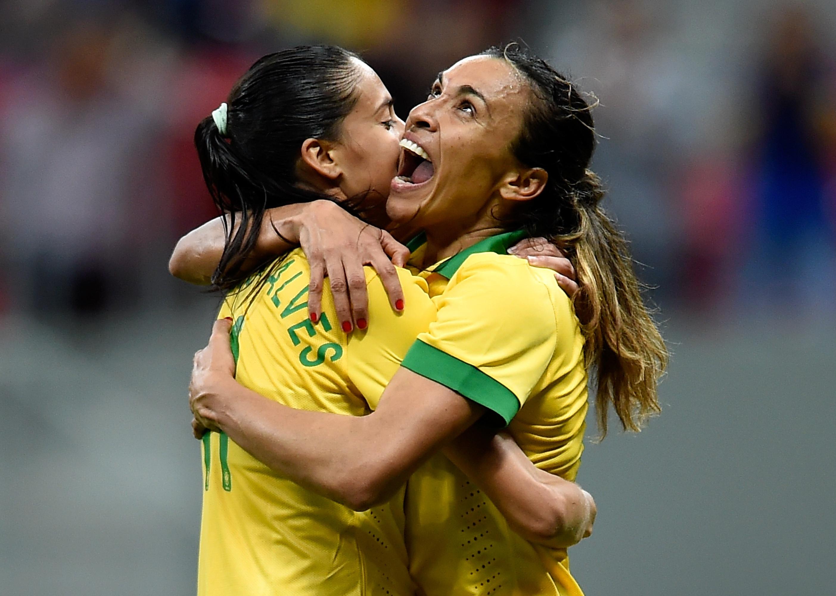 Marta and Andressa of Brazil celebrate the victory against Argentina during a match.