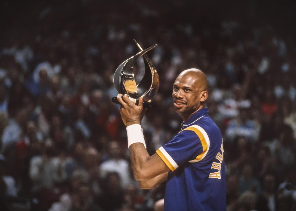 Kareem Abdul-Jabbar holds a trophy