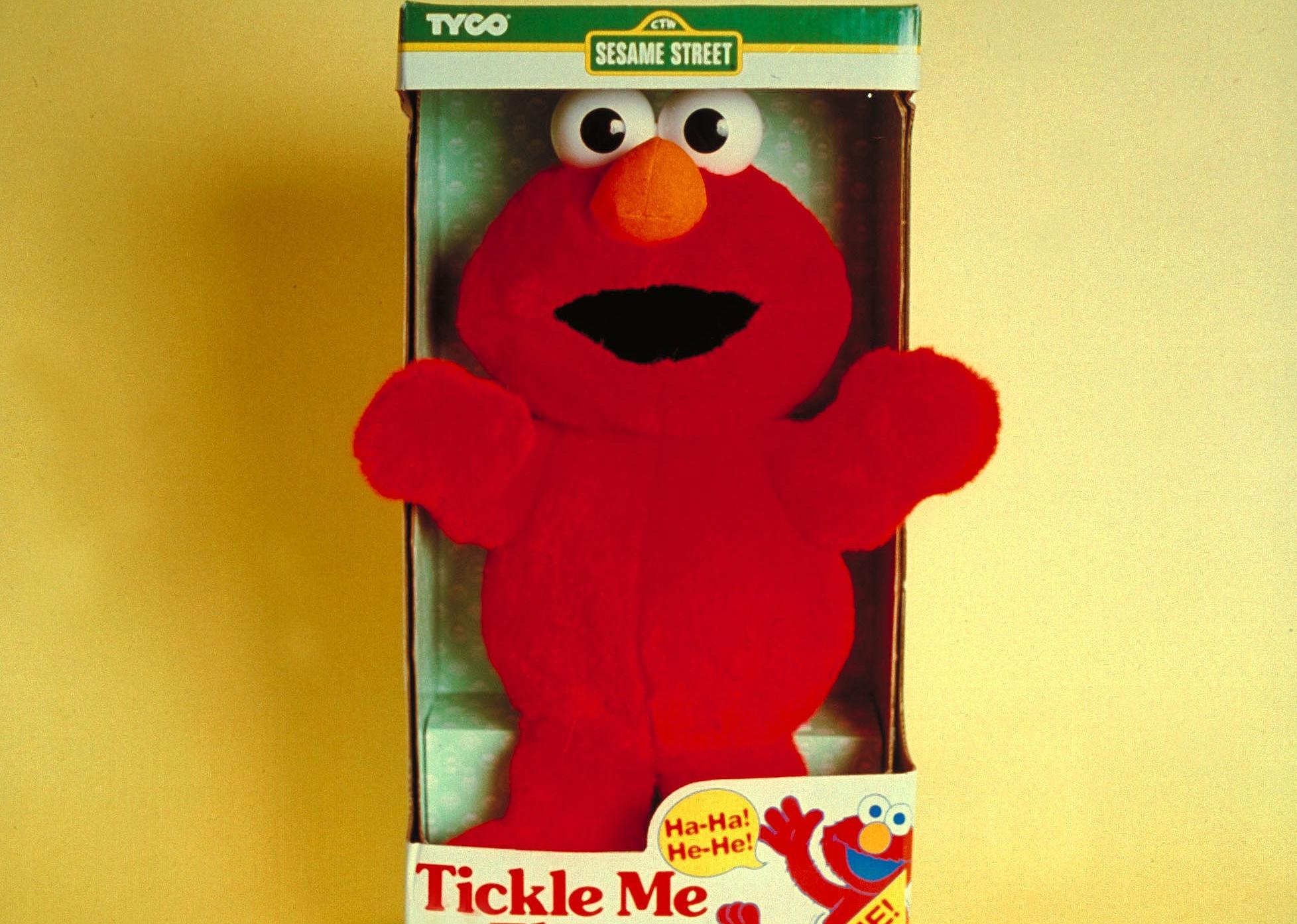 Tickle Me Elmo in box.