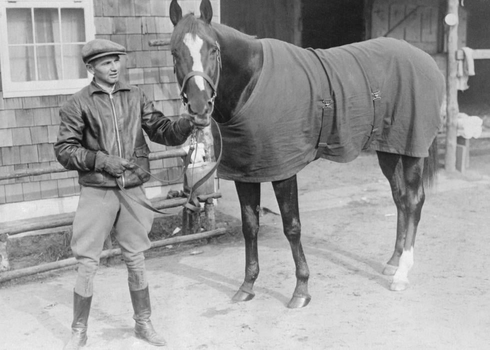 Earl Sande posing with his horse