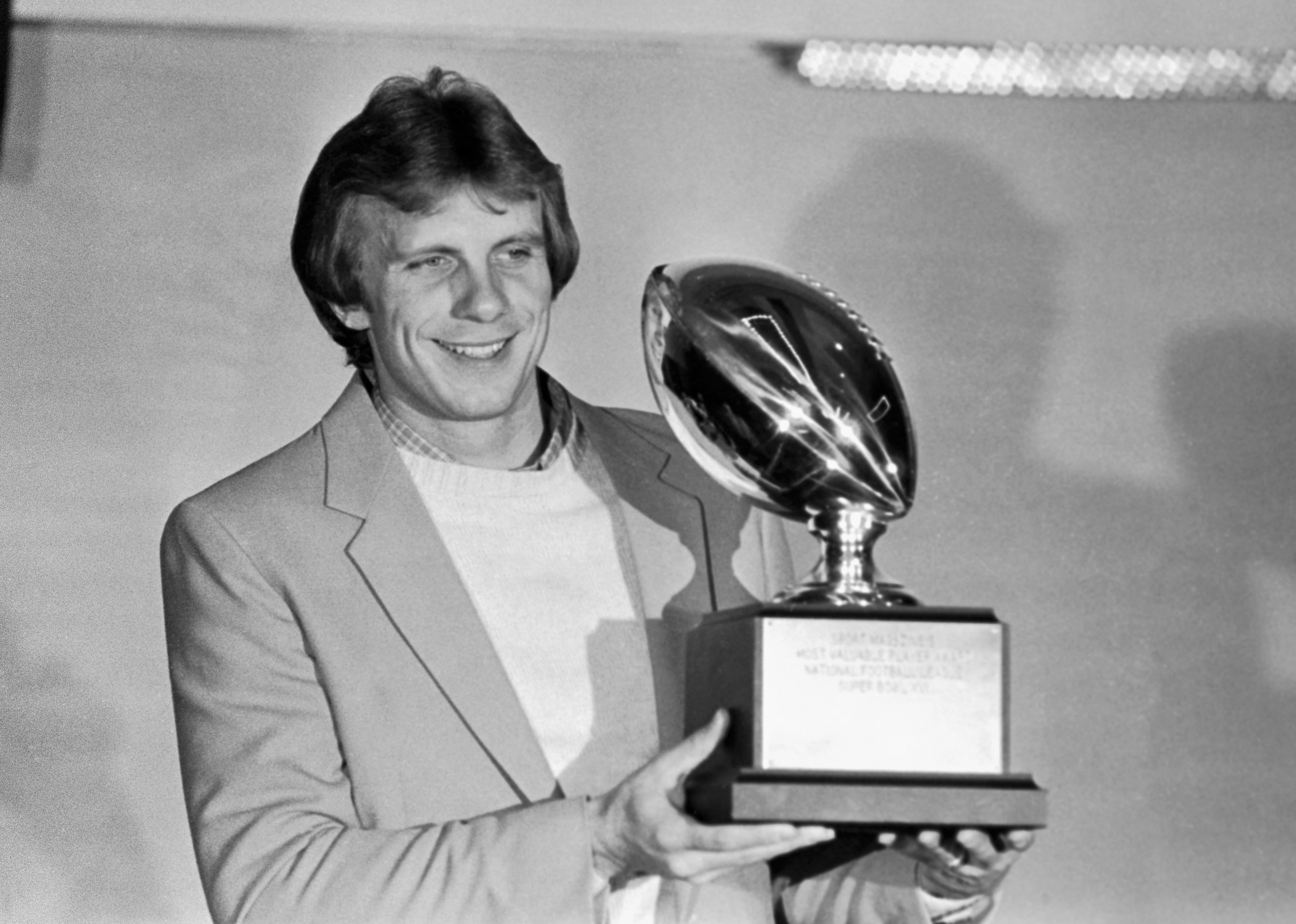 Joe Montana poses with his Super Bowl Most Valuable Player trophy.
