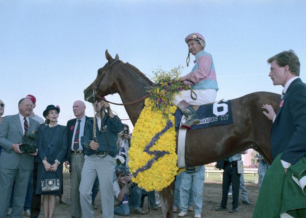 William Shoemaker smiles as he rides into the Winner's Circle