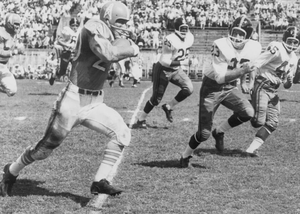 Billy Cannon runs for a 24-yard gain against the New York Titans