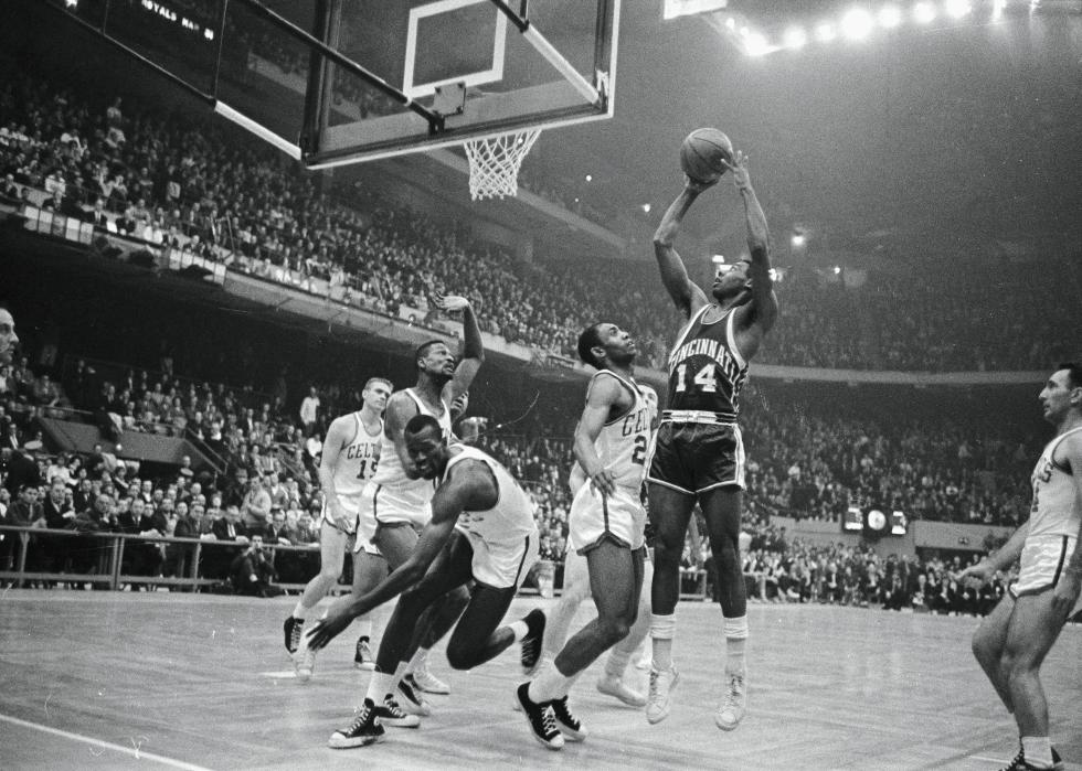 Black-and-white, wide shot of Oscar Robertson shooting a ball during a game against the Celtics