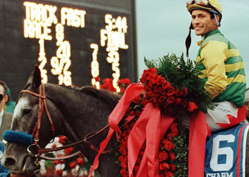 Gary Stevens poses for photographers after winning the 123rd Kentucky Derby