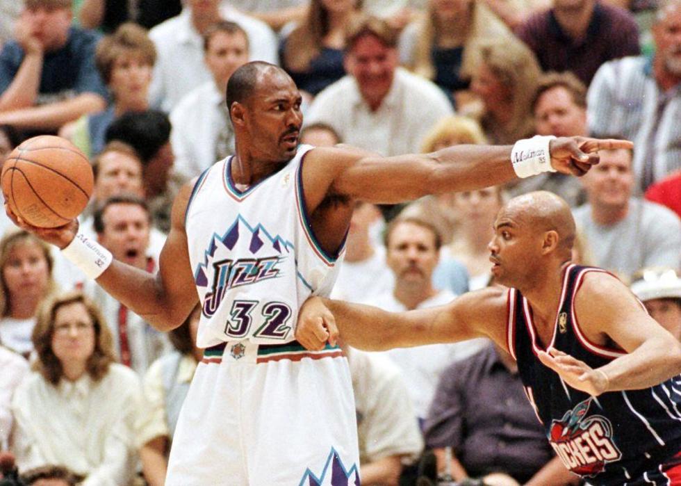 Karl Malone is guarded by Houston Rockets Charles Barkley during a game