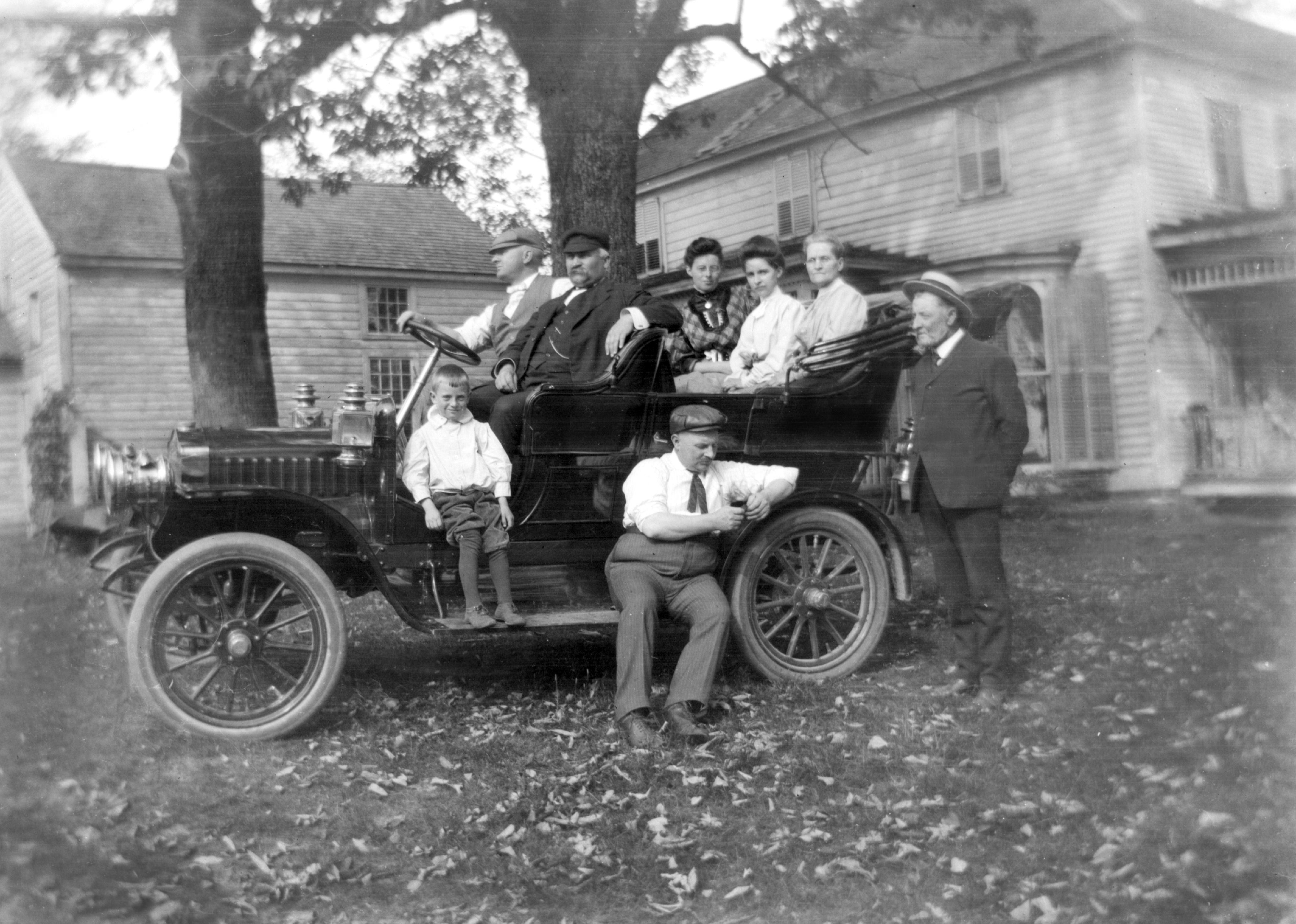 A family gets ready for a car ride in 1920.