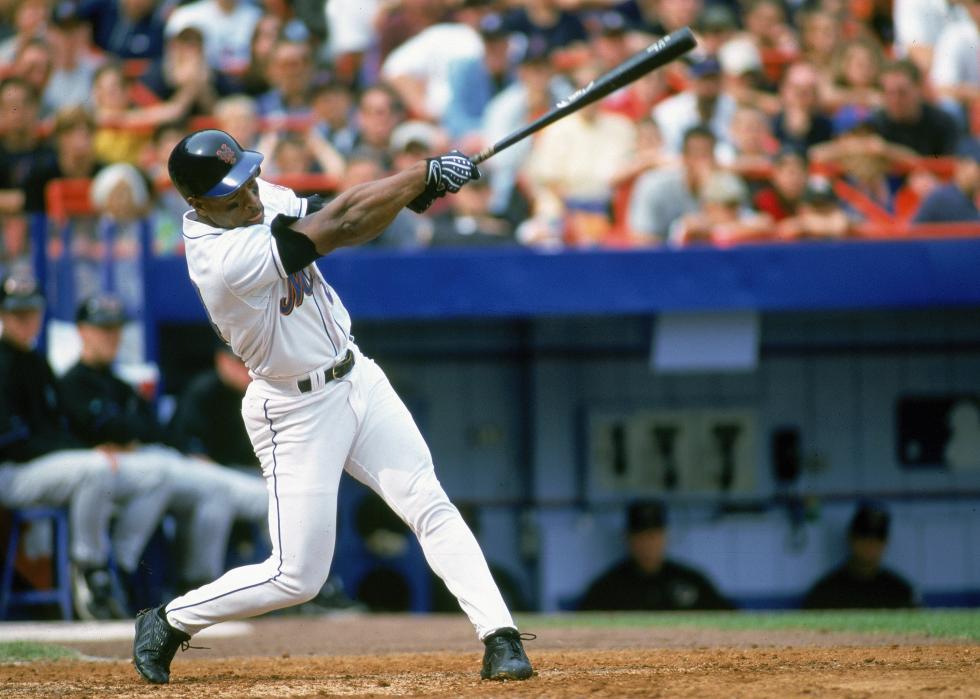 Rickey Henderson swings at the ball during a game