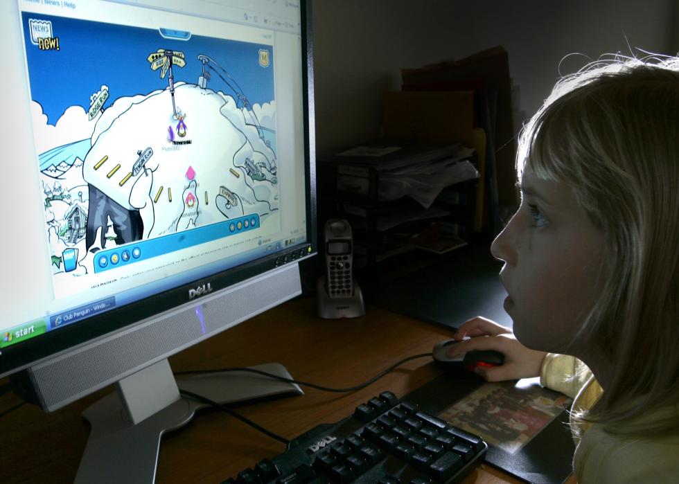 Kid plays Club Penguin on computer