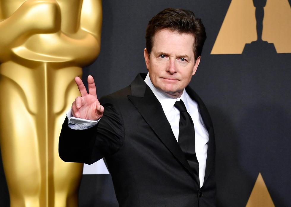 Michael J. Fox with a large Golden Globe statue in the background.