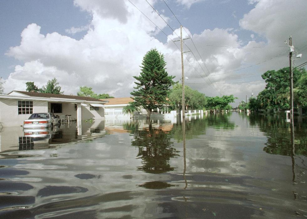 A residential street flooded with at least a couple of feet of water.