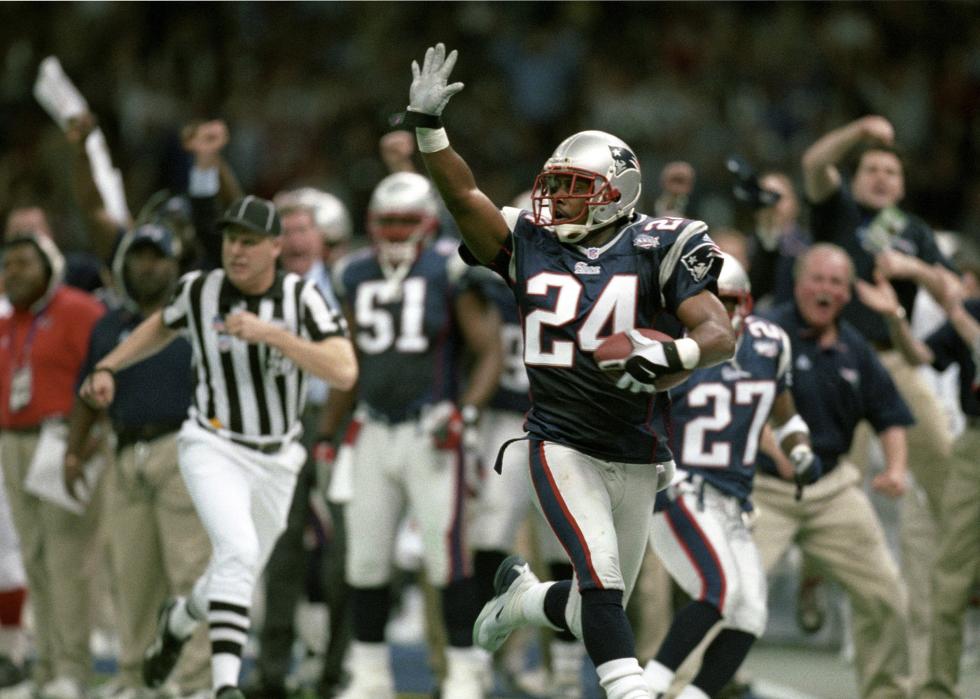 New England Patriots cornerback Ty Law waves to the crowd after intercepting a pass.