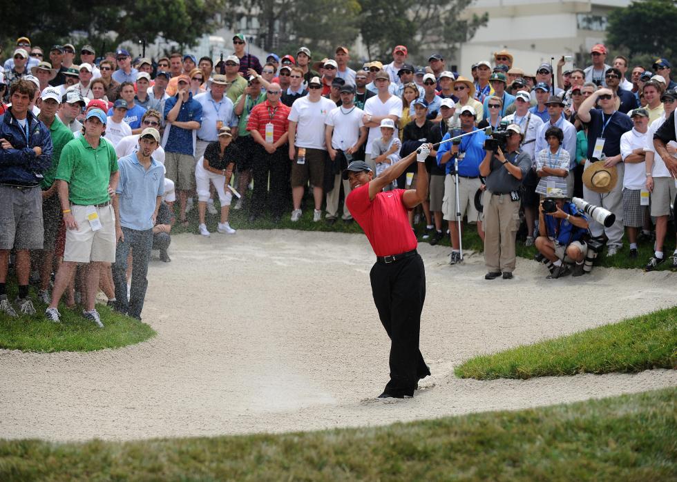 Tiger Woods hits out of a bunker on the 14th hole in the 108th U.S. Open
