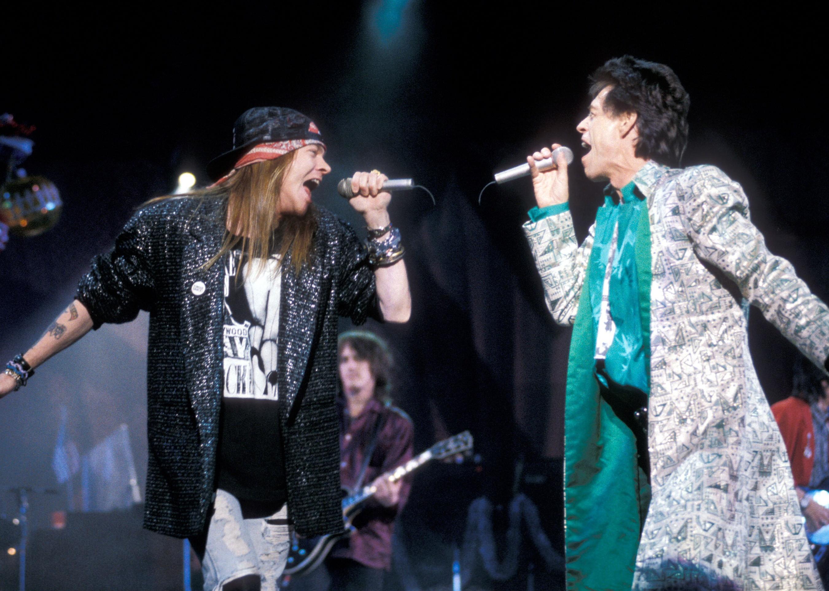 Axl Rose of Guns N' Roses and Mick Jagger of the Rolling Stones performing.