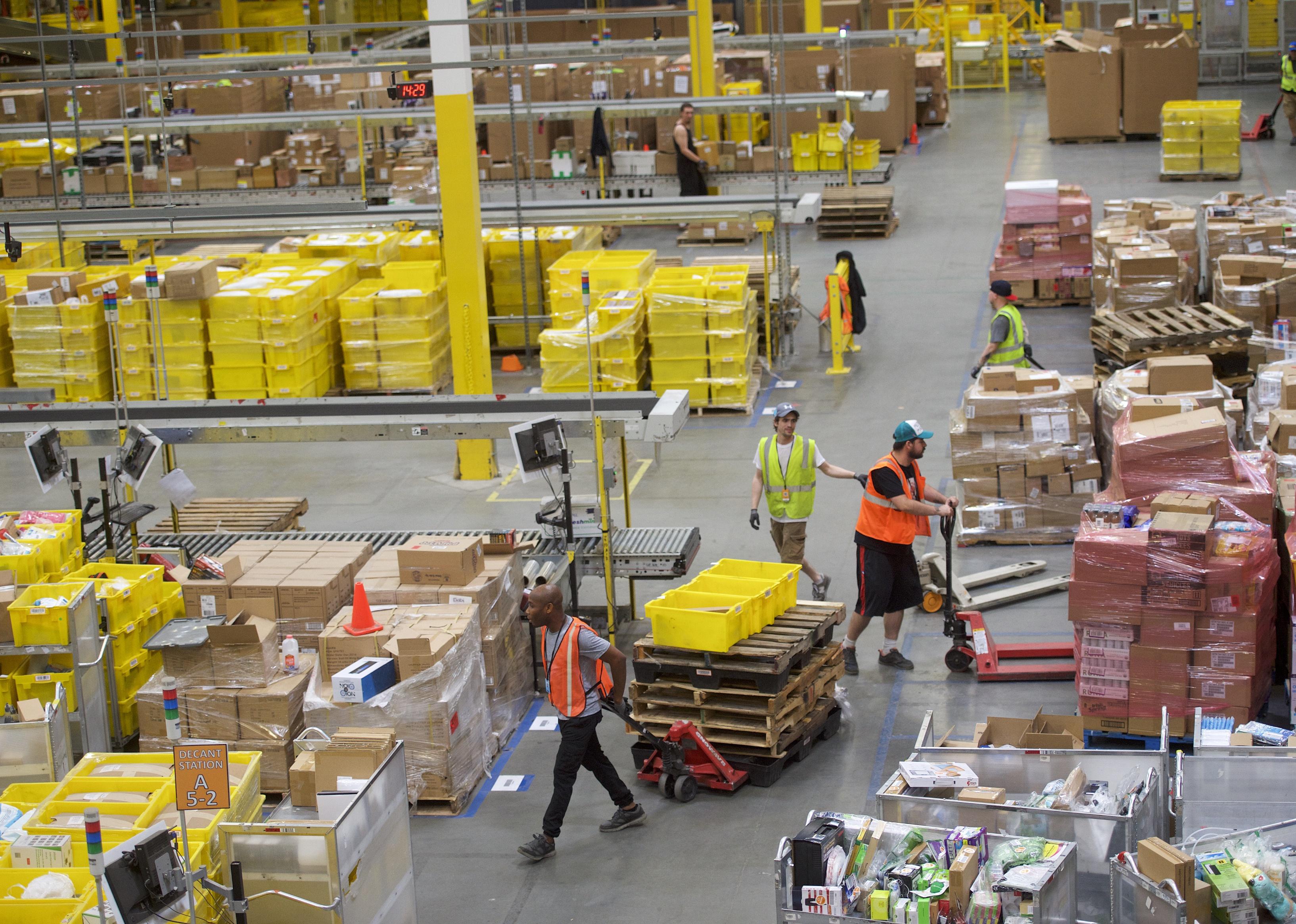 Employees work at an Amazon Fulfillment Center