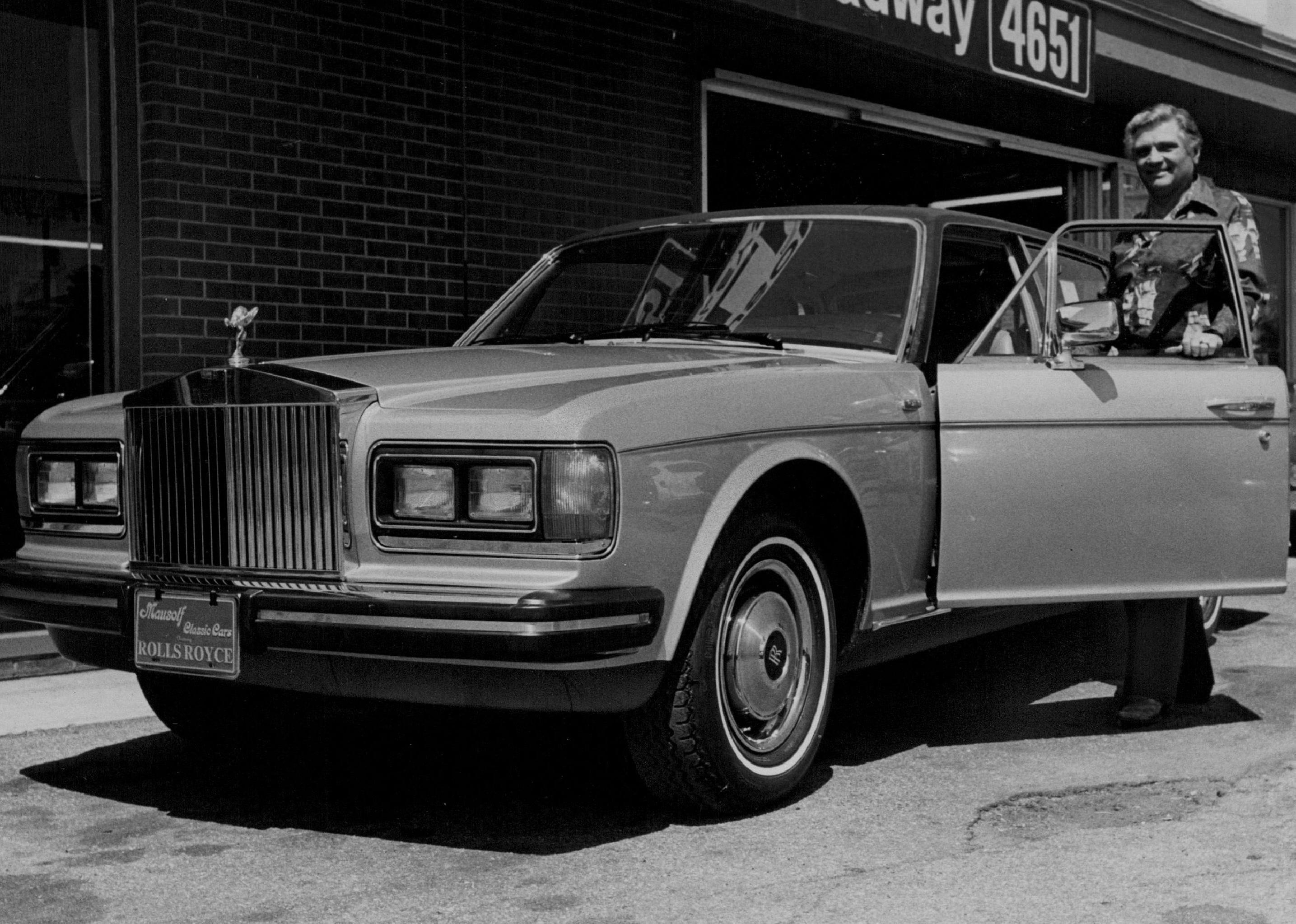 1981 Rolls-Royce parked outside a shop.
