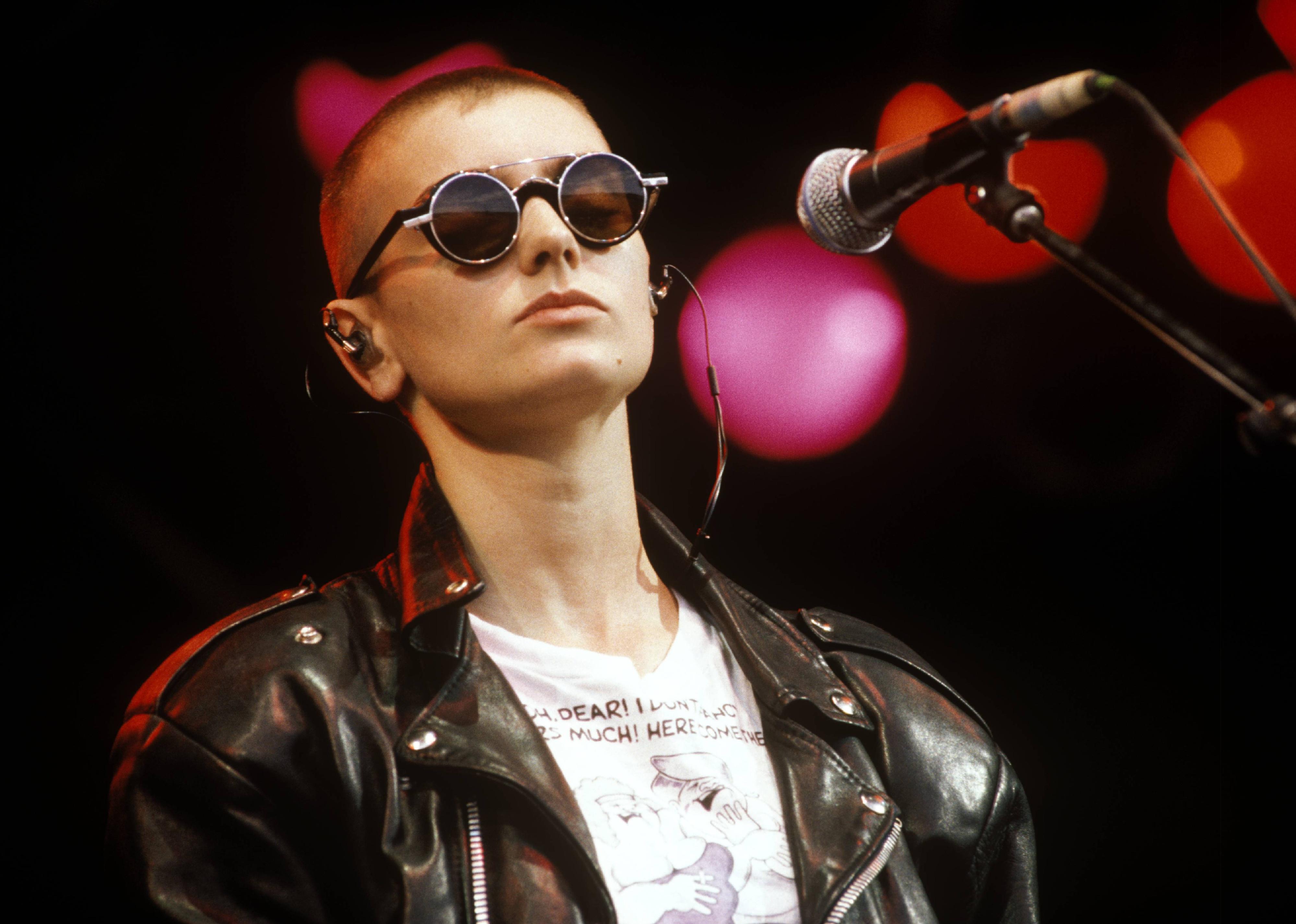 Sinead O'Connor performing on stage. 