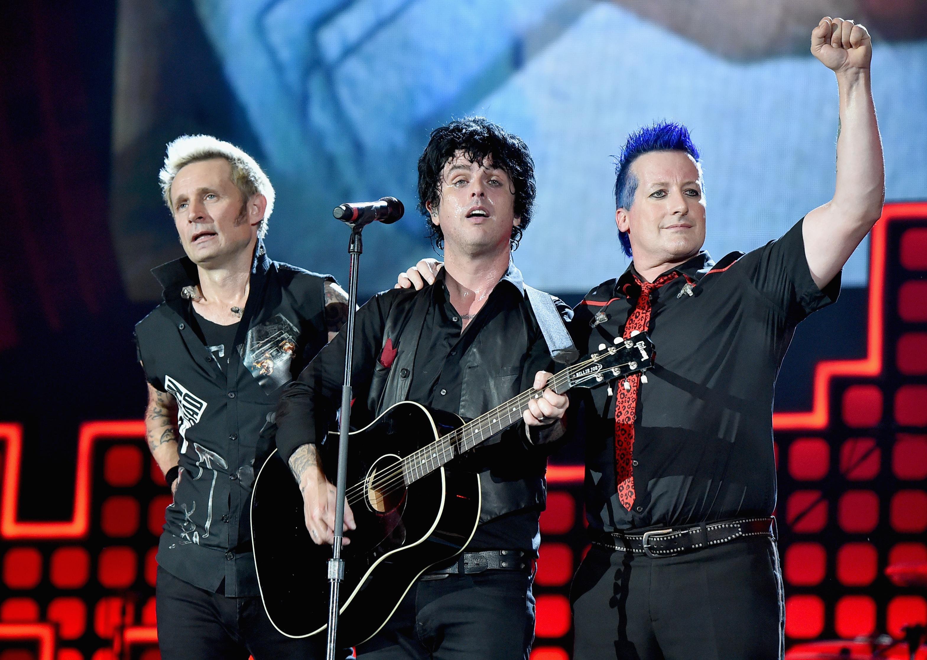 Green Day performing onstage.