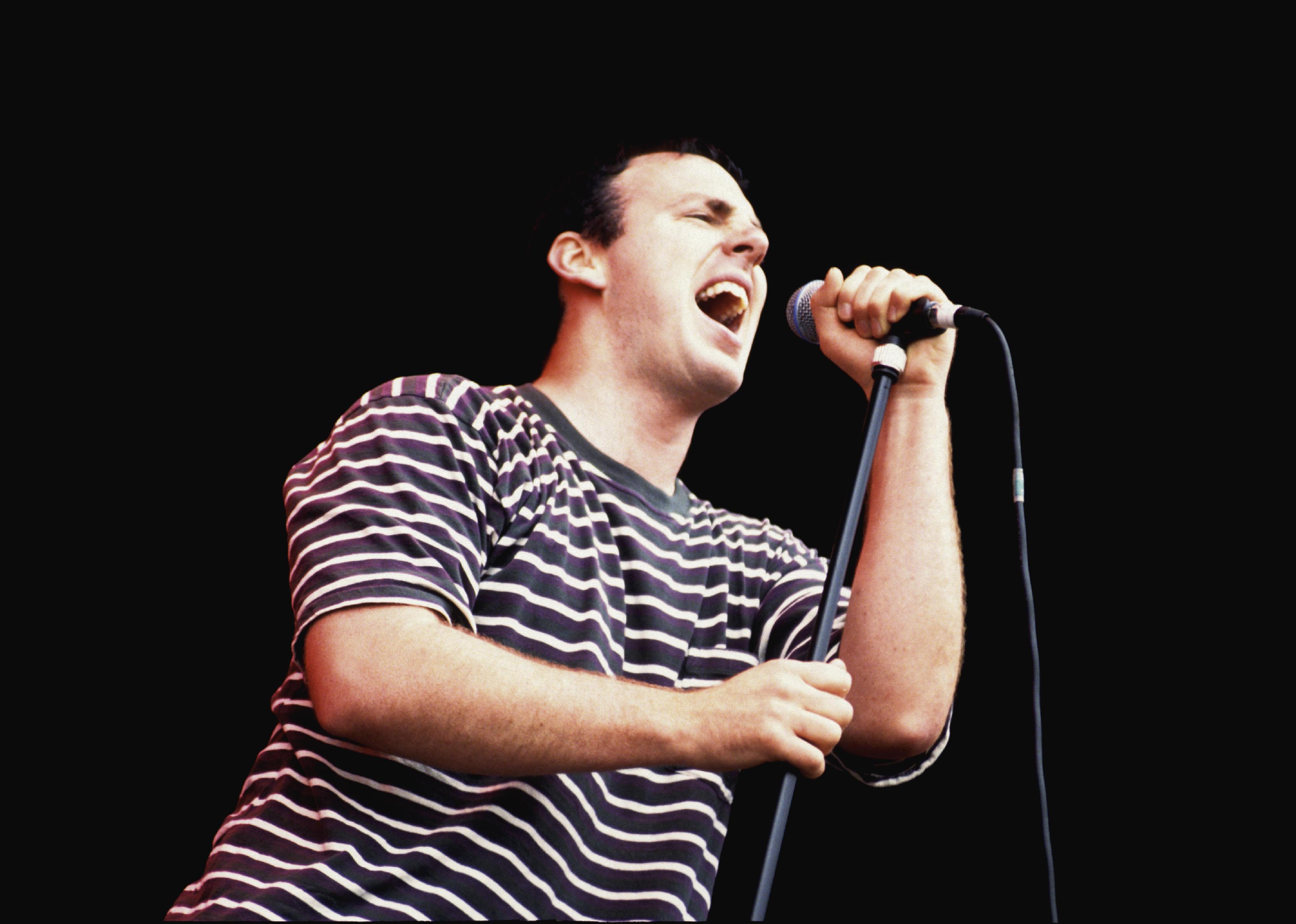 Greg Graffin performing on stage.