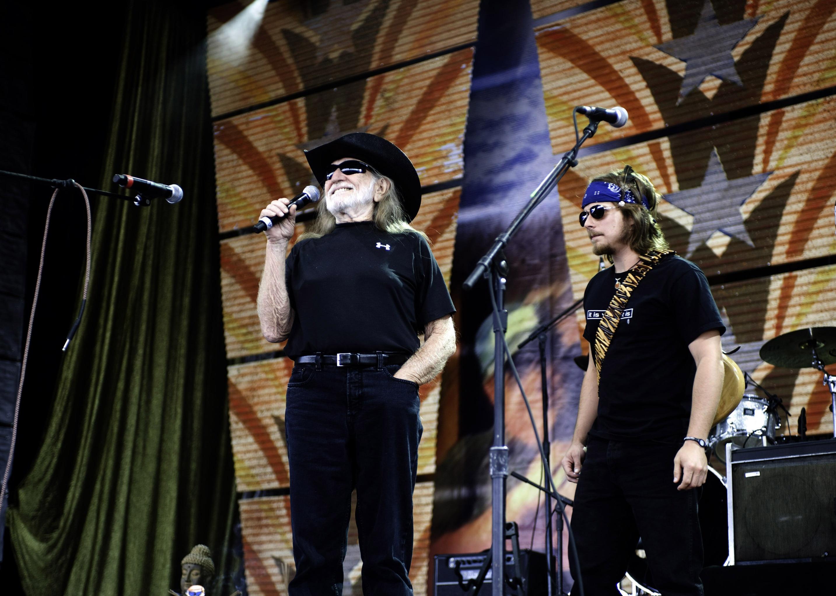 Willie Nelson and Lukas Nelson on stage at Farm Aid 2009.