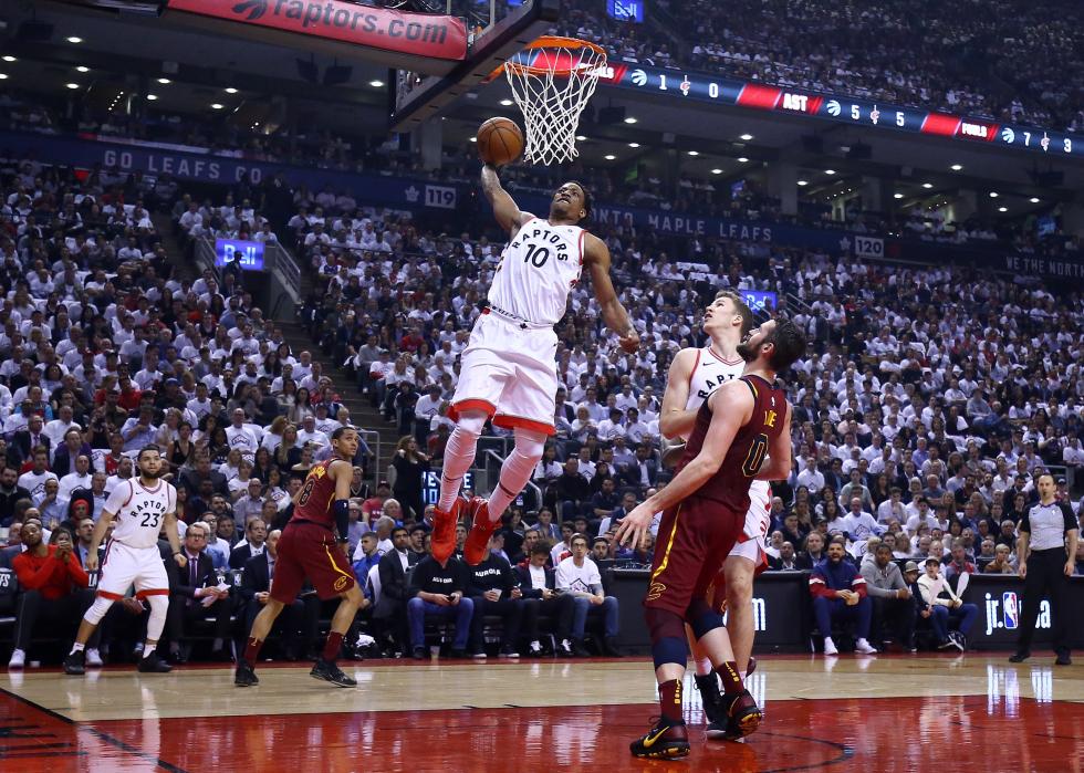 Wide shot of DeMar DeRozan dunking a ball during a game against the Cavaliers 