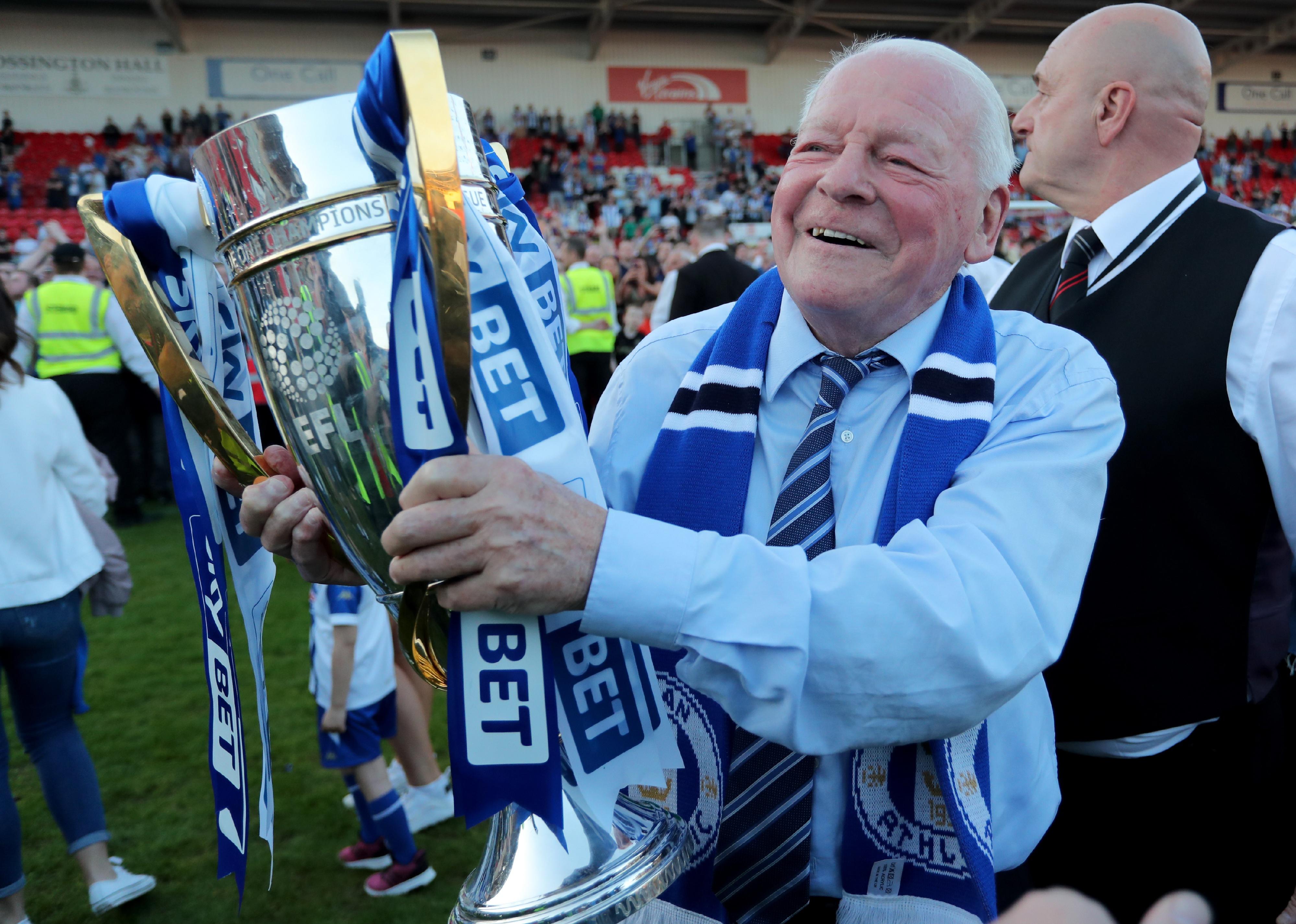 Dave Whelan after a win with a trophy