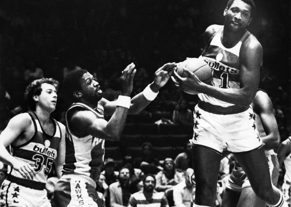 Black-and-white photos of Washington Bullets' Elvin Hayes running with a basketball