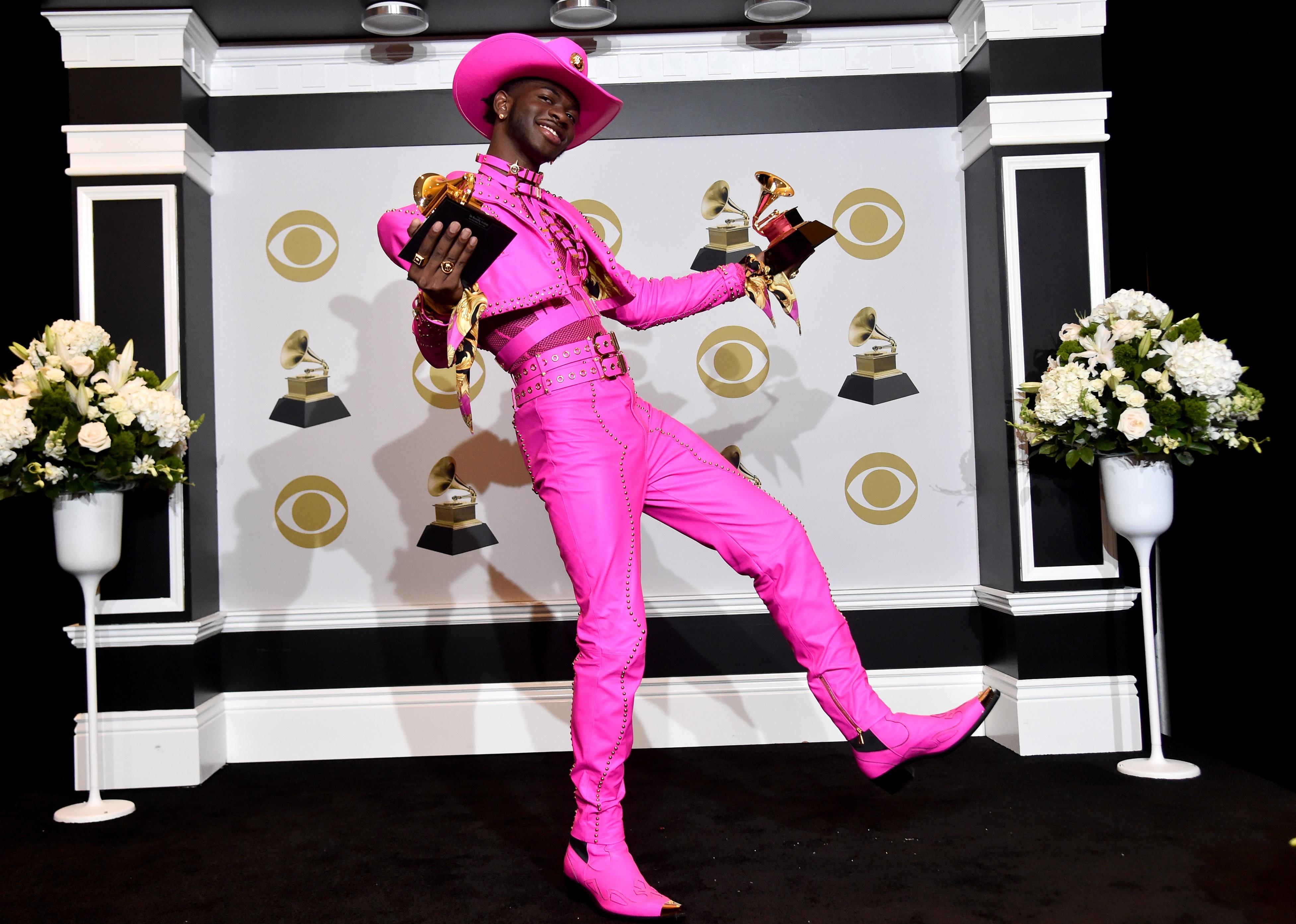 Lil Nas X in a hot pink leather cowboy outfit.