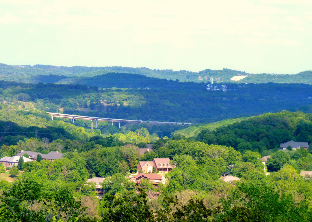 A highway and homes in the green hills in Branson.