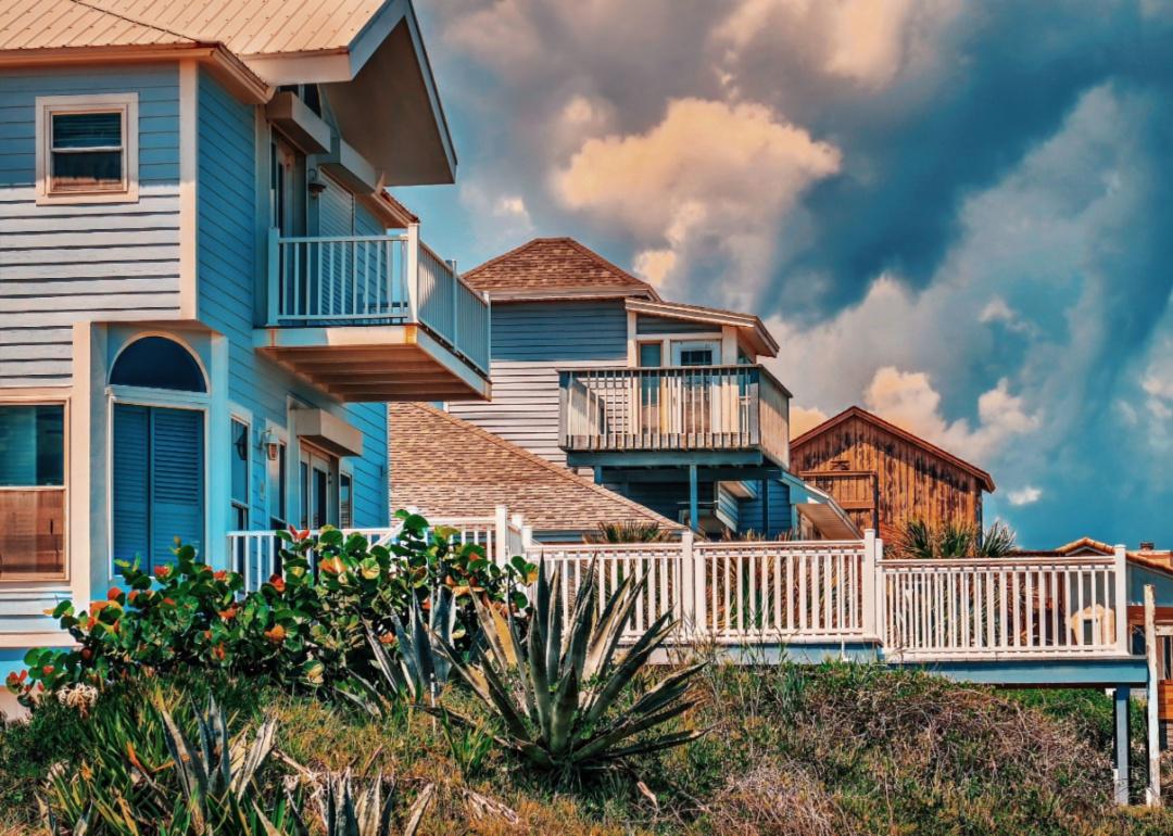 Tall beach houses with porches.