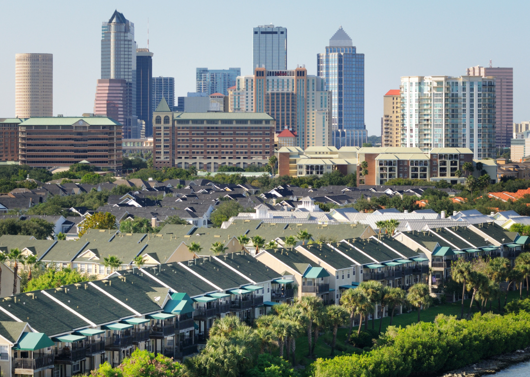Long rows of beach homes with the Tampa, Florida skyline in the background.