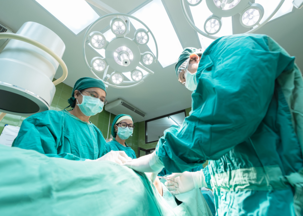 Surgery team dressed in green scrubs.