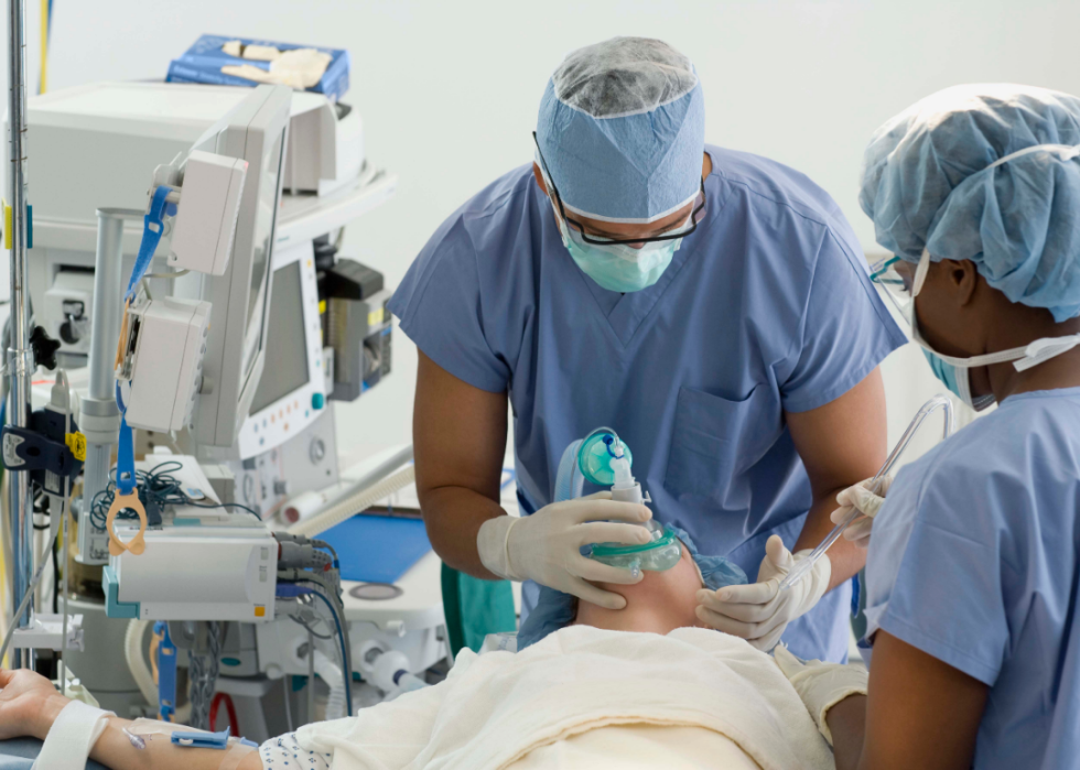 Doctor and nurse working on a patient.