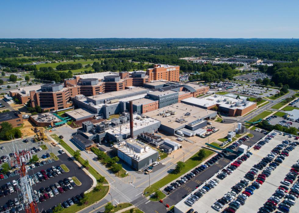 Aerial view of the exterior of a hospital and parking lot.