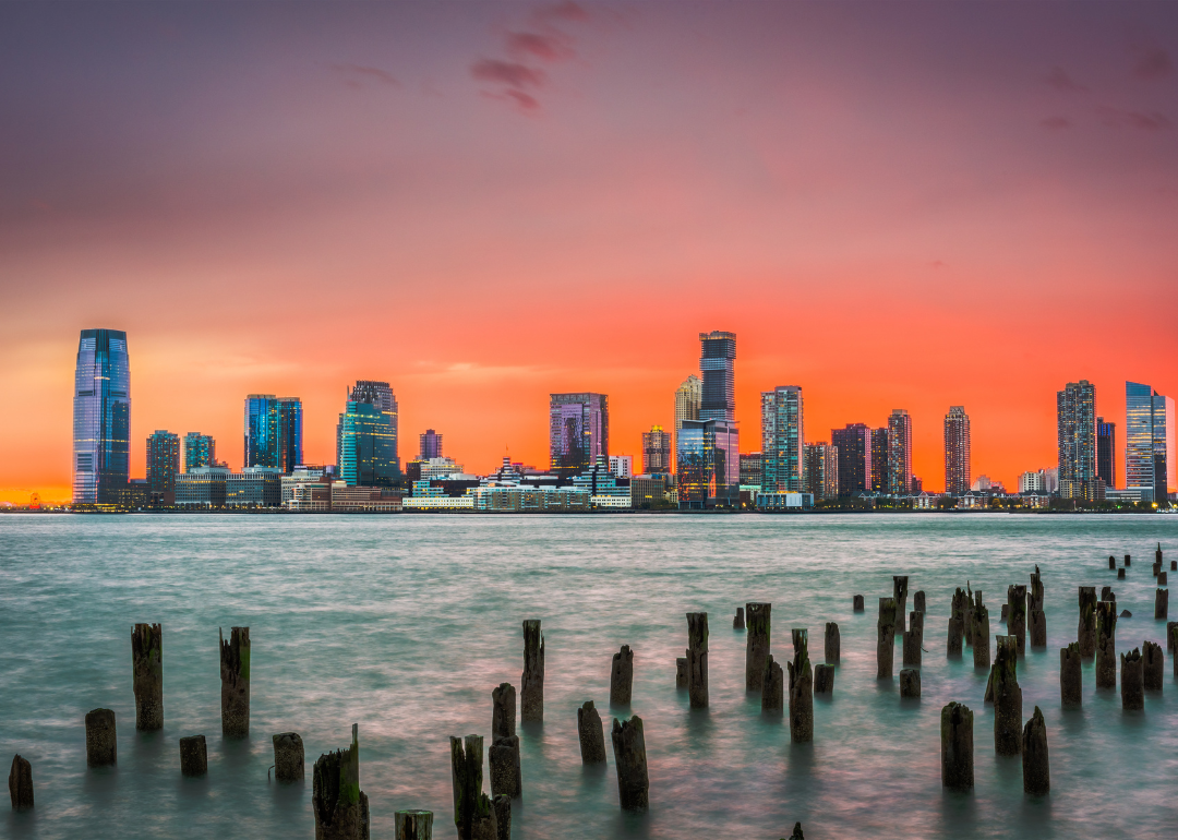 The Jersey City skyline from the water at sunset.