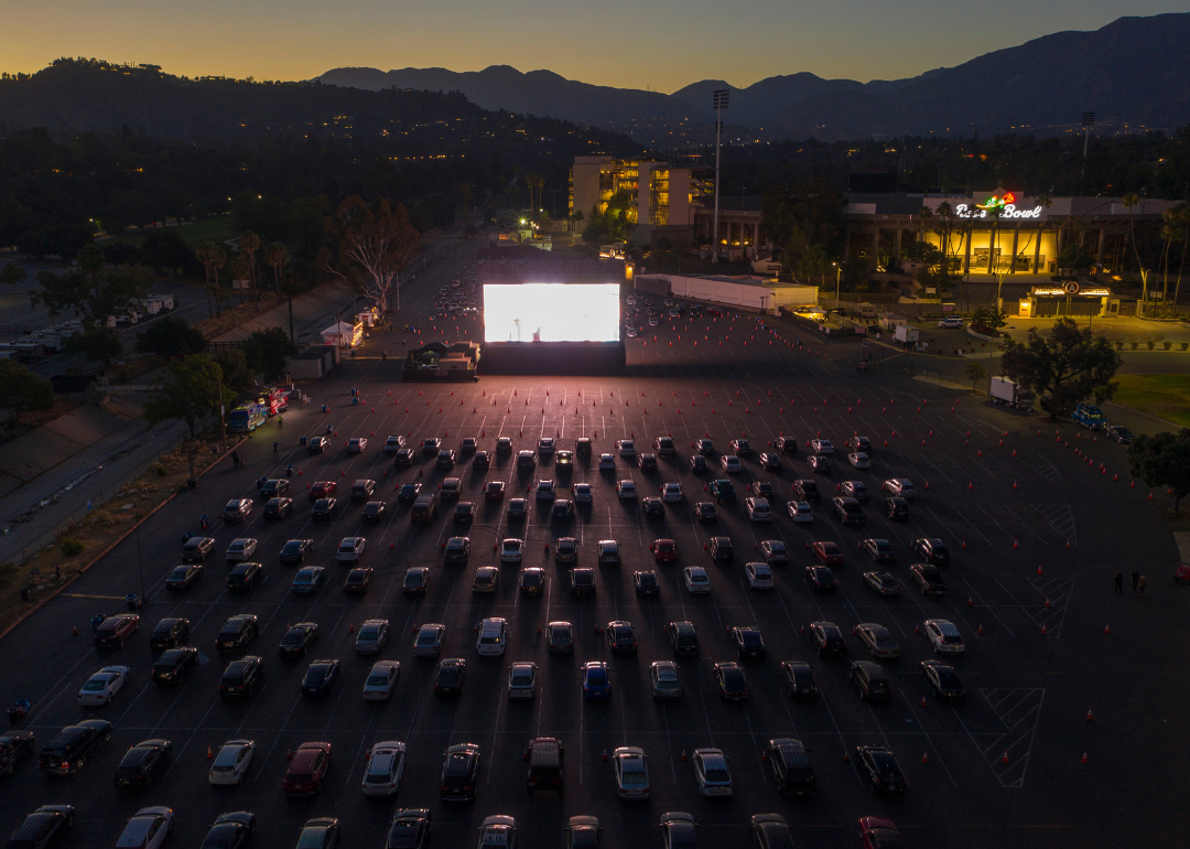 A drive-in movie theater filled with cars.