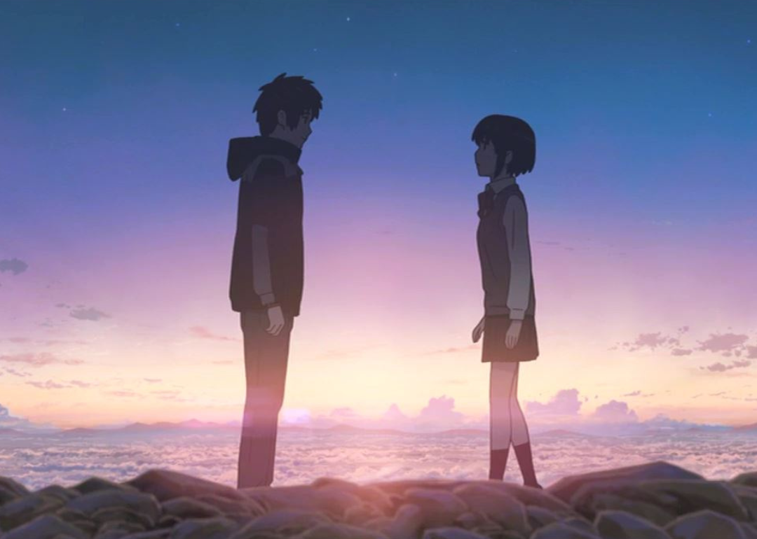 An animation of a boy and a girl standing in the clouds looking at one another..