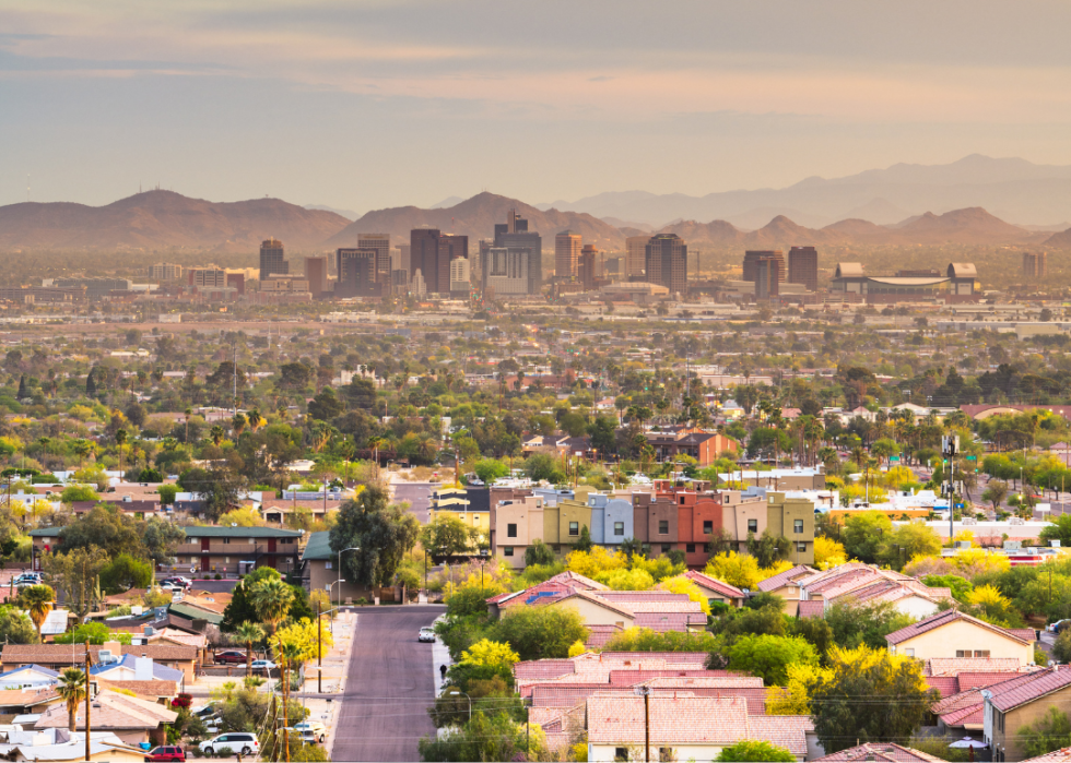 Aerial view of homes with downtown Phoenix, AZ in the background.