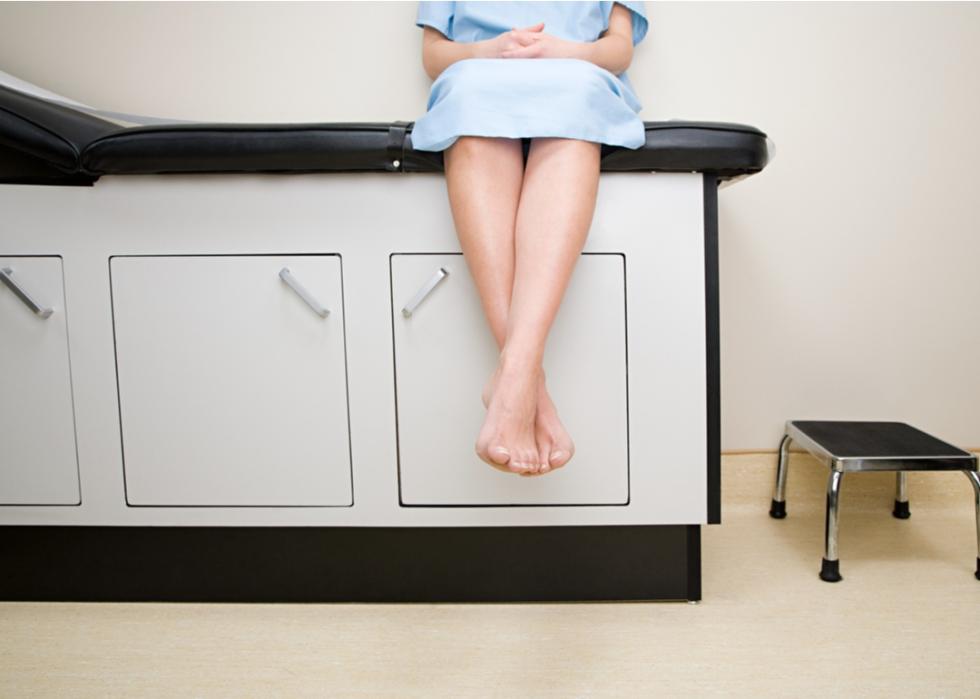 Woman sitting in treatment room.