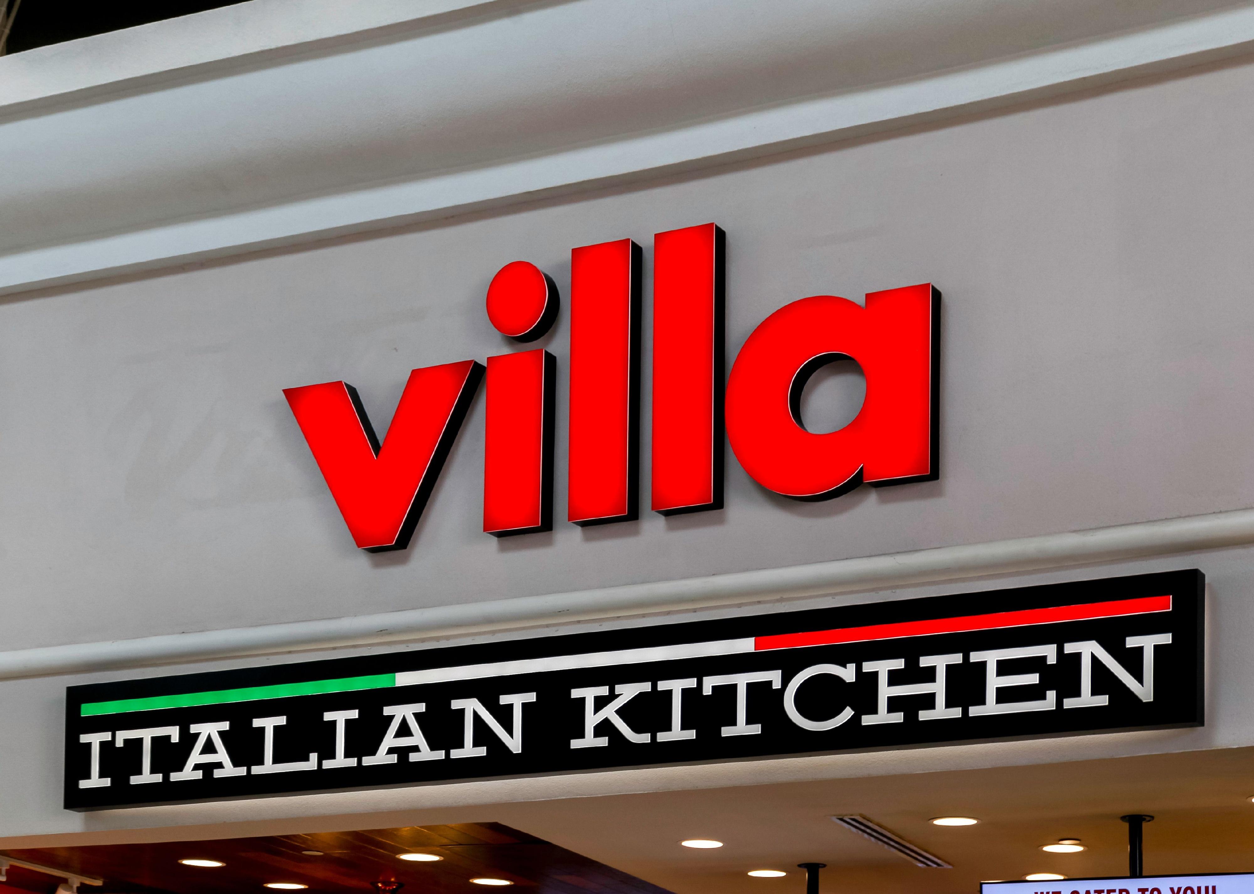 A neon Villa Italian Kitchen sign.