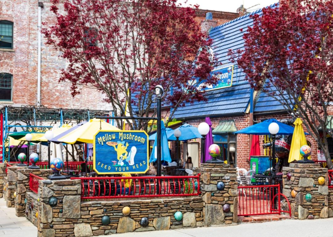 A colorful stone Mellow Mushroom entrance and patio.