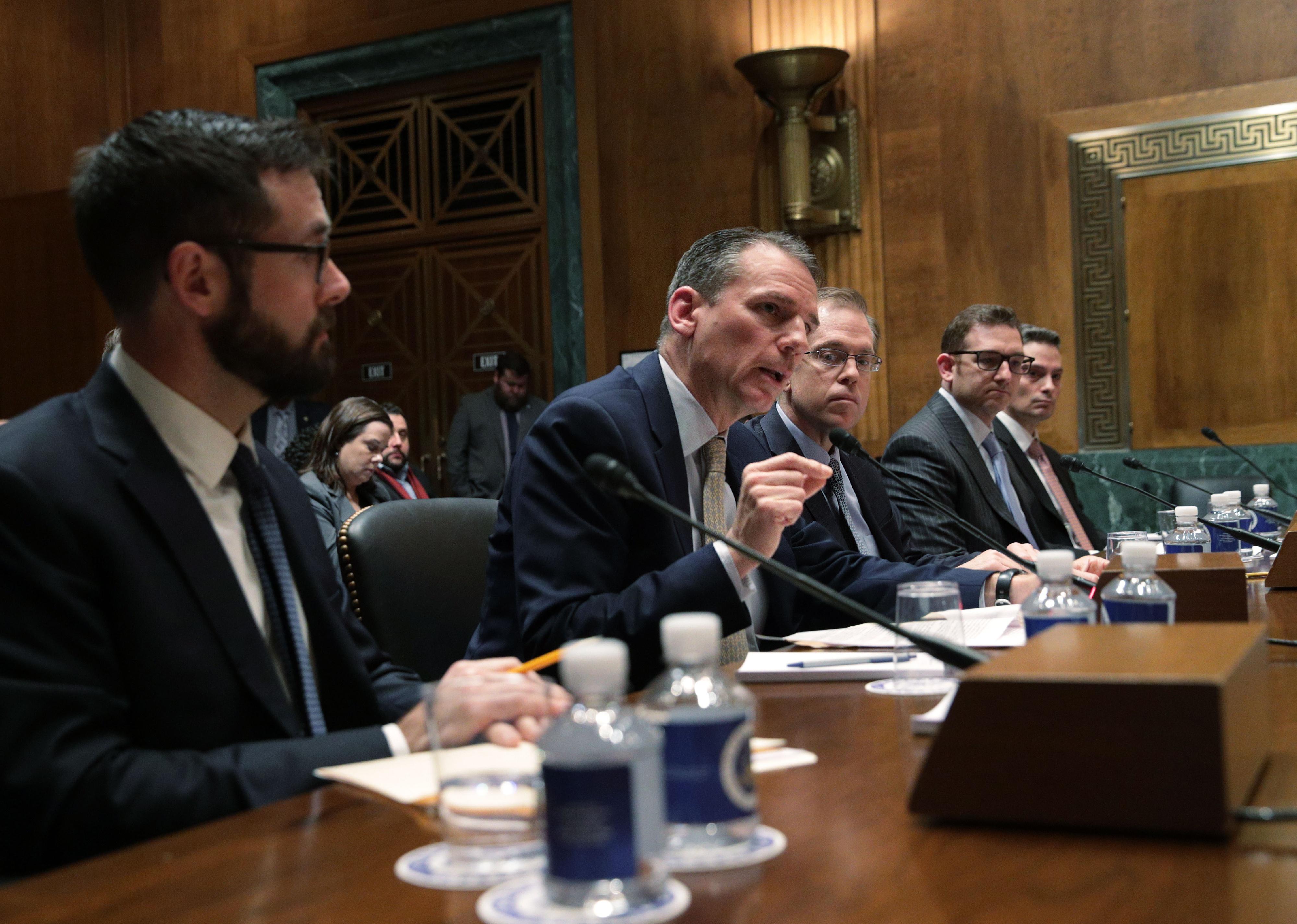 A row of men testifying during a hearing before the Senate Judiciary Committee in Washington, D.C.